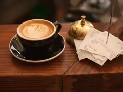 Sample: cappuccino on a wooden café table