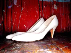 Sample: white high-heel shoes on a red floor